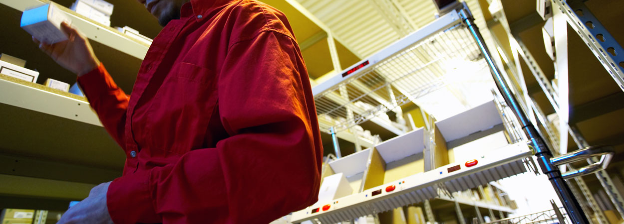 warehouse worker using pick to cart system for order fulfillment